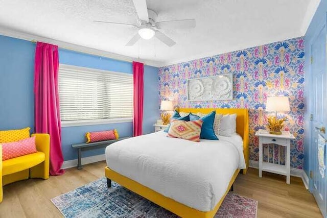 bedroom featuring ceiling fan, wood finished floors, and baseboards