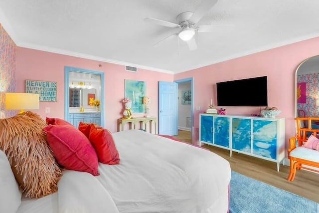 bedroom with ensuite bath, visible vents, wood finished floors, and ornamental molding