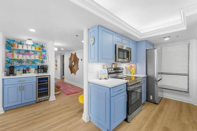 kitchen featuring blue cabinetry, light wood-style flooring, wine cooler, and stainless steel appliances