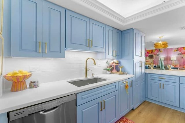 kitchen with a sink, blue cabinetry, ornamental molding, and dishwasher