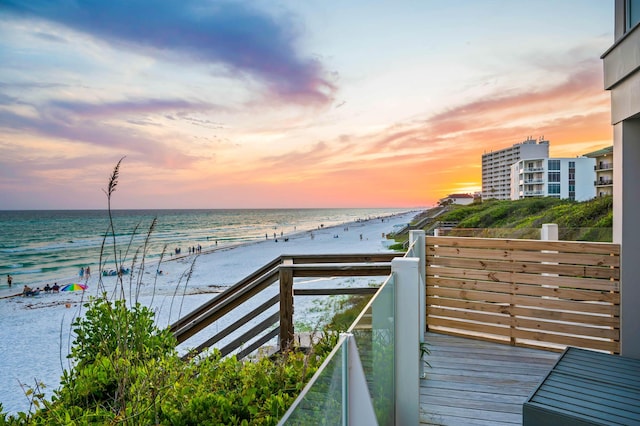 balcony featuring a water view and a beach view