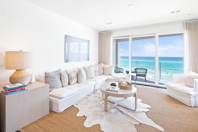 living room with a water view and visible vents