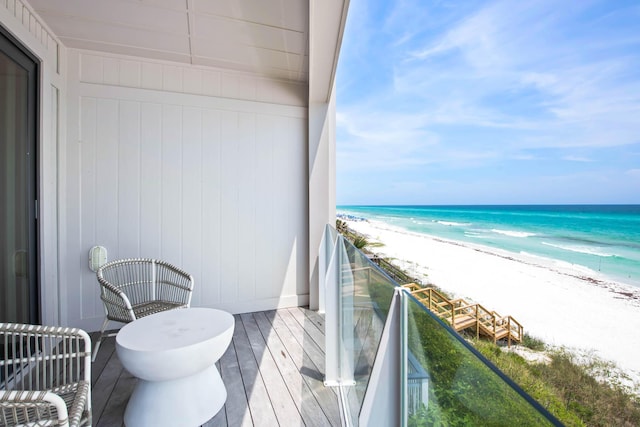 balcony with a view of the beach and a water view