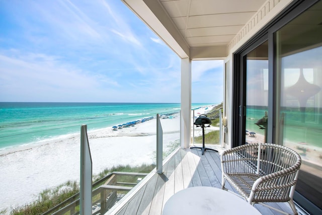 balcony with a water view and a beach view