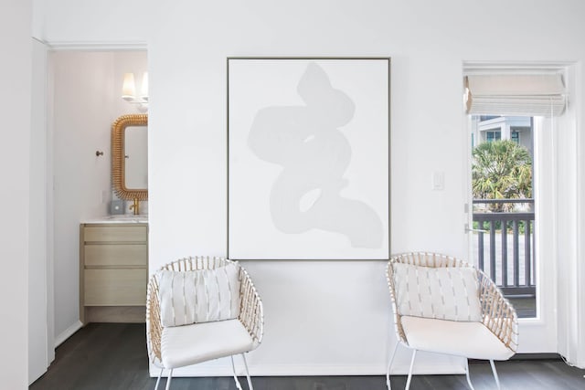 sitting room featuring baseboards and wood finished floors