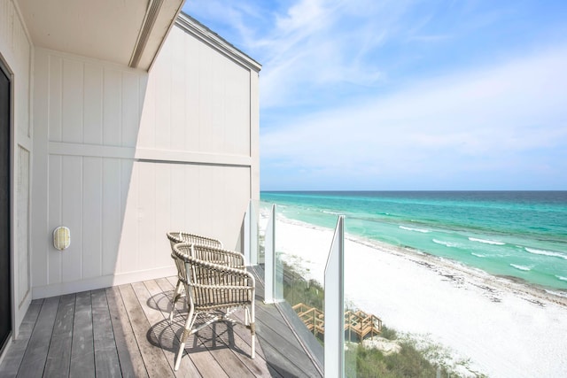 balcony with a beach view and a water view