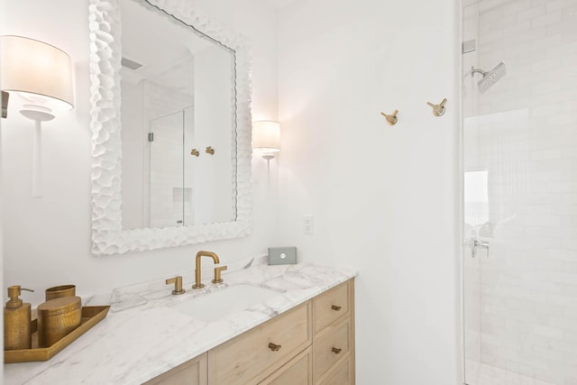 full bath featuring visible vents, a shower stall, and vanity