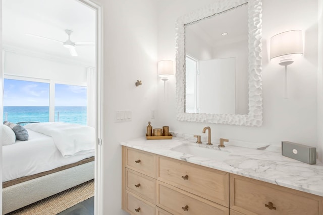 bathroom featuring a water view, connected bathroom, vanity, and ceiling fan