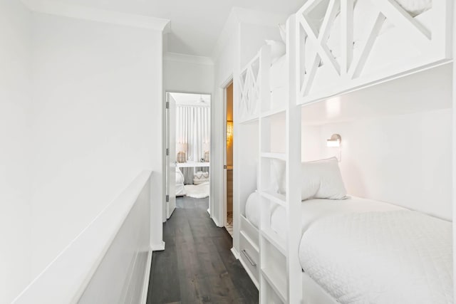 bedroom featuring ornamental molding and dark wood-style flooring