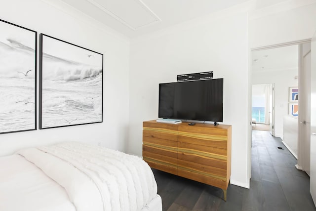 bedroom with crown molding and wood finished floors