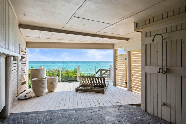 deck featuring a beach view and a water view