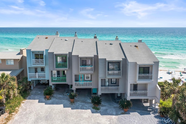 drone / aerial view with a beach view and a water view