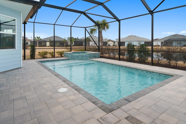 view of pool featuring a patio, a residential view, a lanai, and a pool with connected hot tub