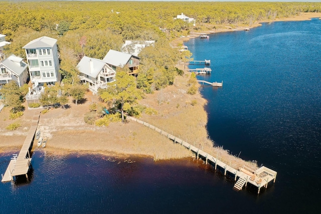 aerial view with a forest view and a water view