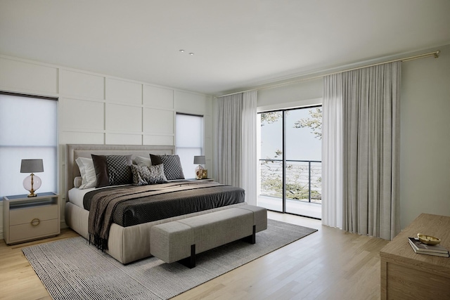 bedroom featuring access to exterior and light wood-style flooring