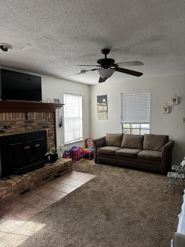 unfurnished living room with a textured ceiling, carpet, a fireplace, and a ceiling fan