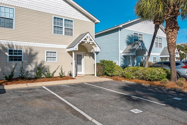 view of property featuring uncovered parking