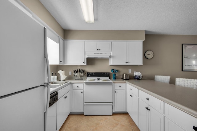 kitchen with white appliances, under cabinet range hood, white cabinets, and light tile patterned flooring