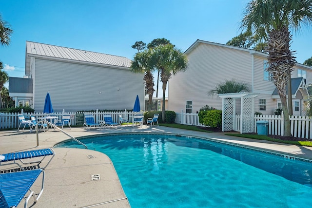 pool with fence and a patio