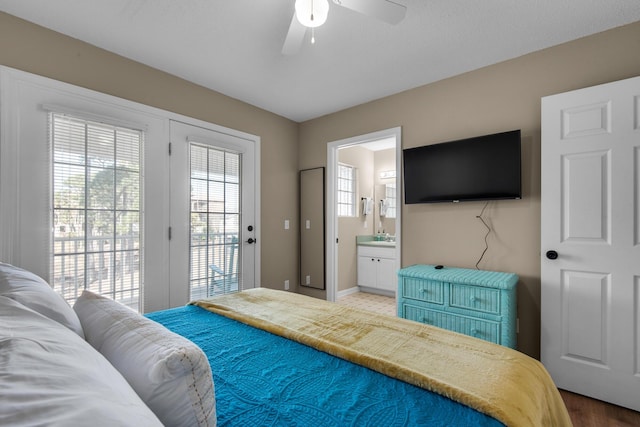 bedroom with access to exterior, baseboards, a ceiling fan, and ensuite bathroom