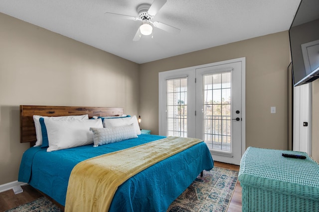 bedroom with baseboards, access to outside, a ceiling fan, and wood finished floors