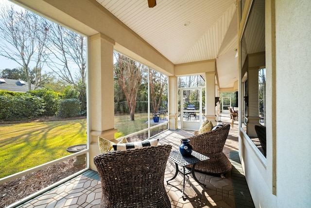 sunroom / solarium featuring vaulted ceiling