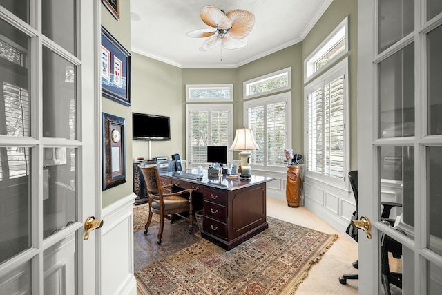 office space with ornamental molding, a decorative wall, and wainscoting