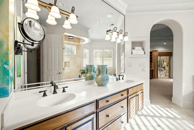 full bathroom featuring double vanity, crown molding, visible vents, and a sink