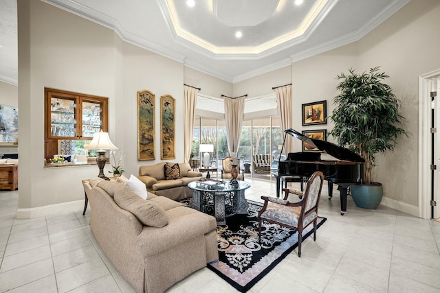 living room featuring baseboards, a tray ceiling, and crown molding