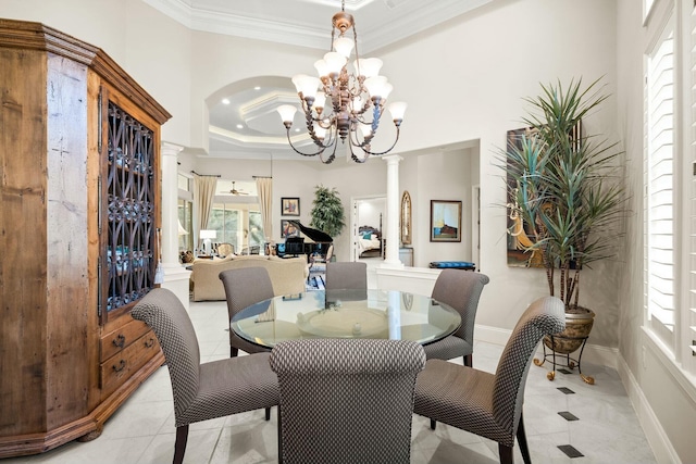 dining room with a healthy amount of sunlight, ornate columns, and ornamental molding