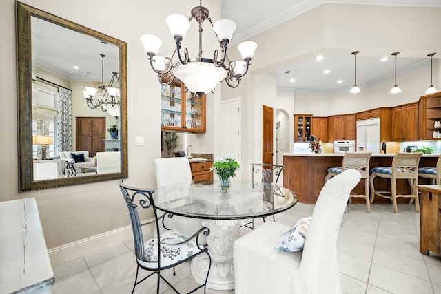 dining area with arched walkways, light tile patterned floors, crown molding, and an inviting chandelier