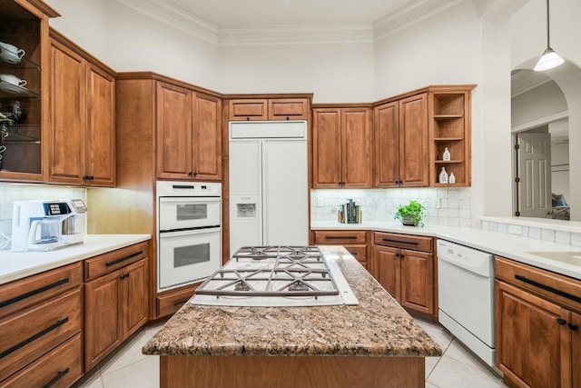 kitchen featuring brown cabinets, white appliances, and open shelves