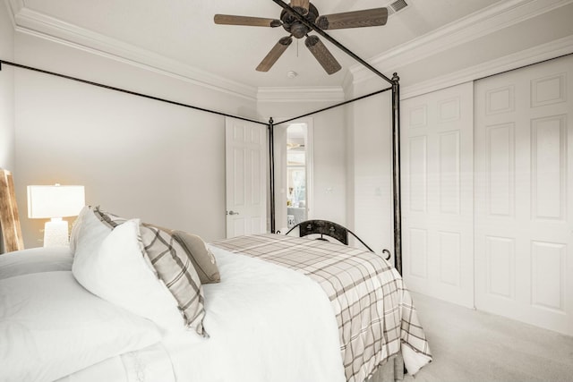 bedroom featuring a closet, visible vents, ornamental molding, carpet flooring, and ceiling fan