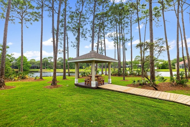 view of community featuring a water view, a lawn, and a gazebo