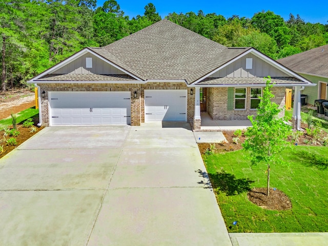 view of front of home featuring a shingled roof, board and batten siding, driveway, brick siding, and a garage