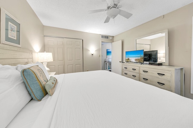 bedroom featuring a textured ceiling, ceiling fan, a closet, and visible vents