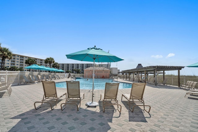 community pool with fence, a pergola, and a patio