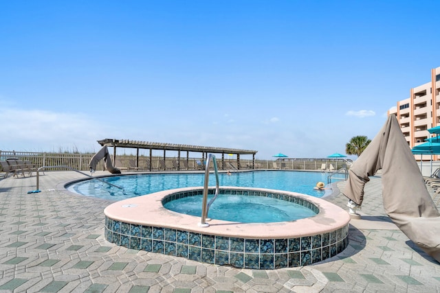 community pool featuring a patio, a community hot tub, and fence