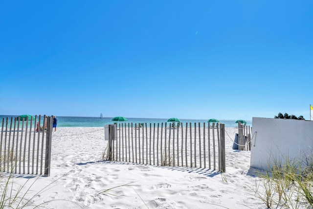 view of yard with a beach view and a water view