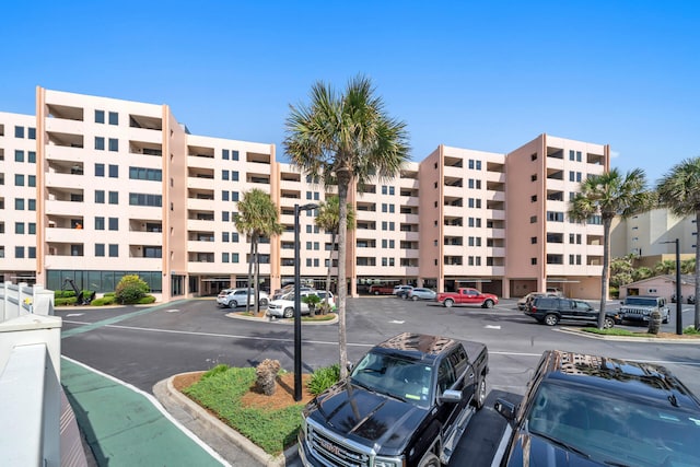 view of building exterior with uncovered parking