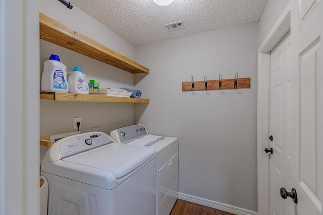 clothes washing area featuring visible vents, a textured ceiling, laundry area, independent washer and dryer, and baseboards