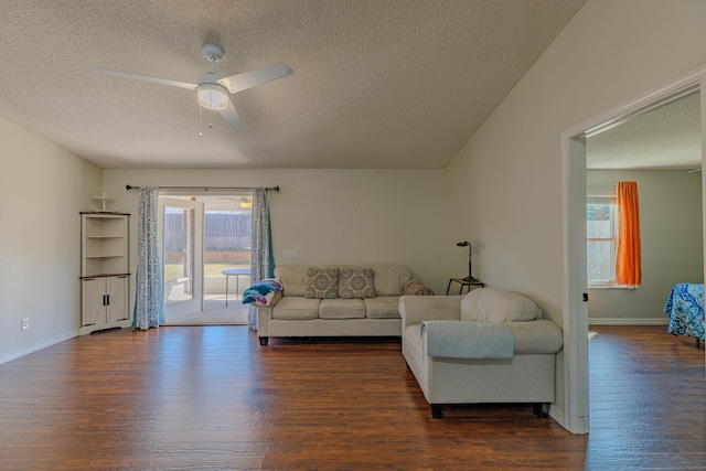 living area with a wealth of natural light, ceiling fan, and wood finished floors