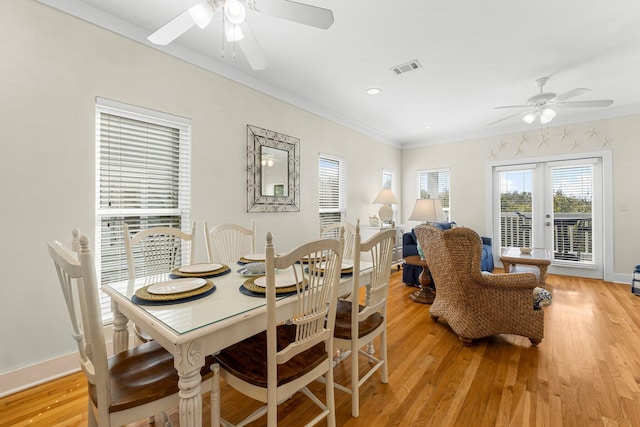 dining room featuring french doors, crown molding, ceiling fan, light wood-type flooring, and baseboards