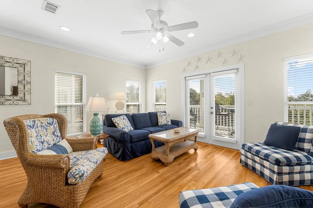 living room with visible vents, ceiling fan, ornamental molding, light wood-type flooring, and recessed lighting