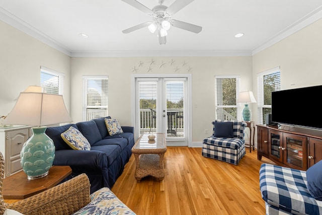 living room with ornamental molding, a wealth of natural light, and light wood-style flooring