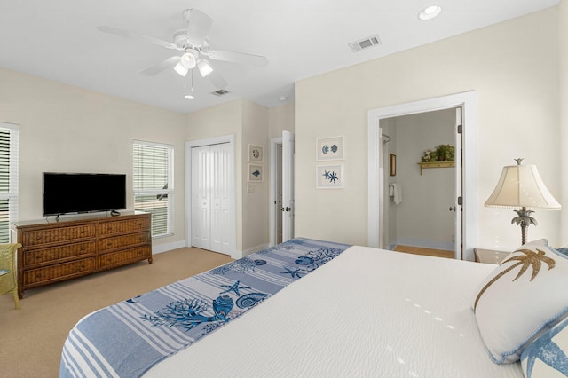 bedroom with carpet, visible vents, ceiling fan, and a closet