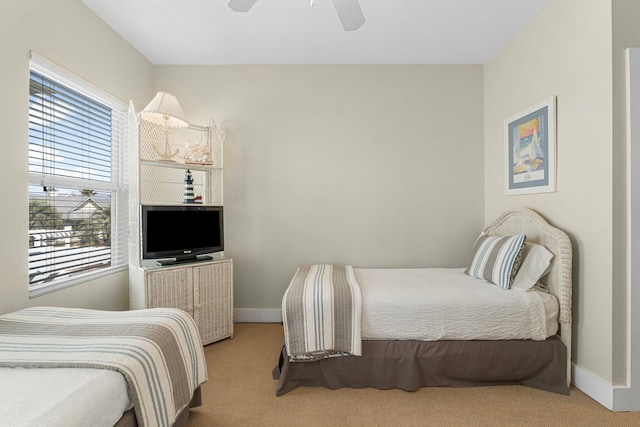 bedroom featuring ceiling fan, carpet, and baseboards