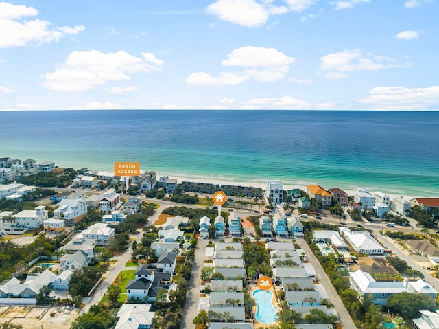 aerial view with a water view, a view of the beach, and a residential view