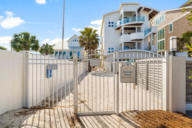 view of gate with a fenced front yard