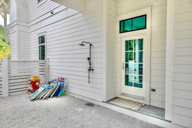 doorway to property featuring fence